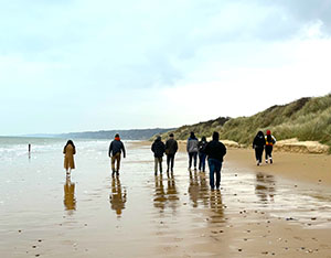 ROTC cadets walk along the beach in Normandy