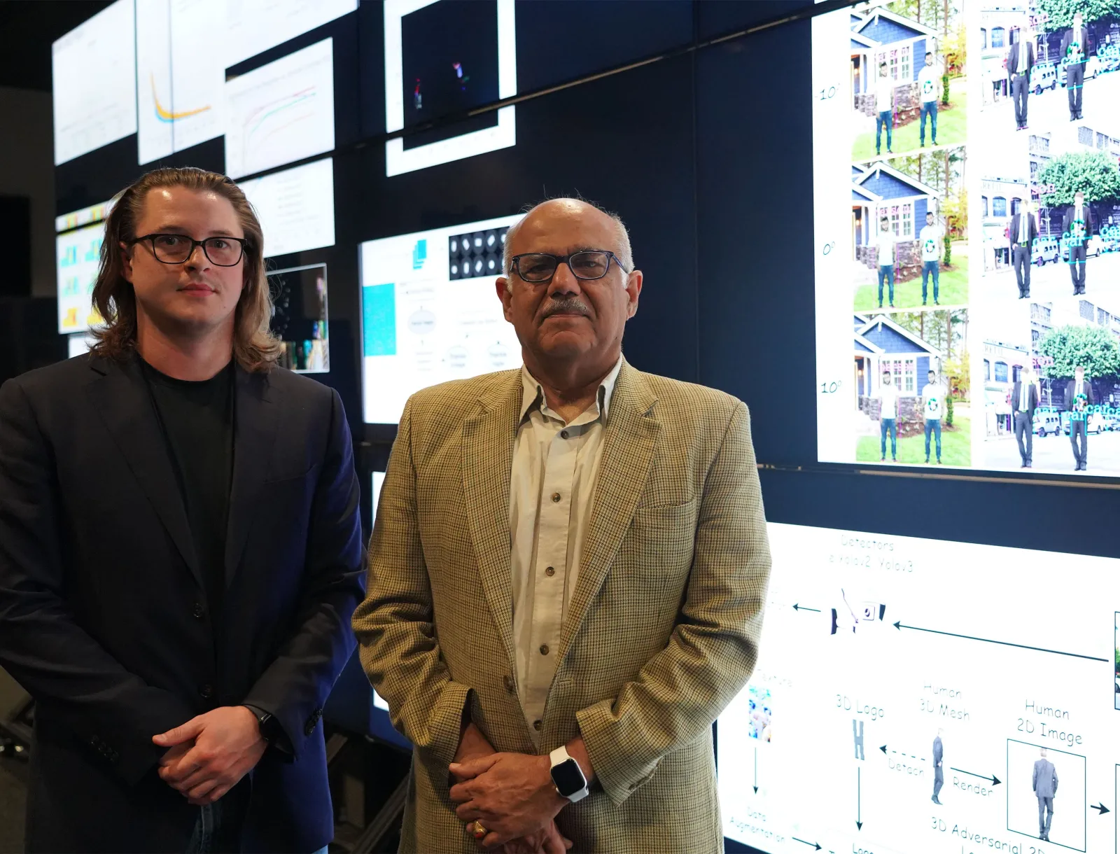 two researchers standing in visualization lab