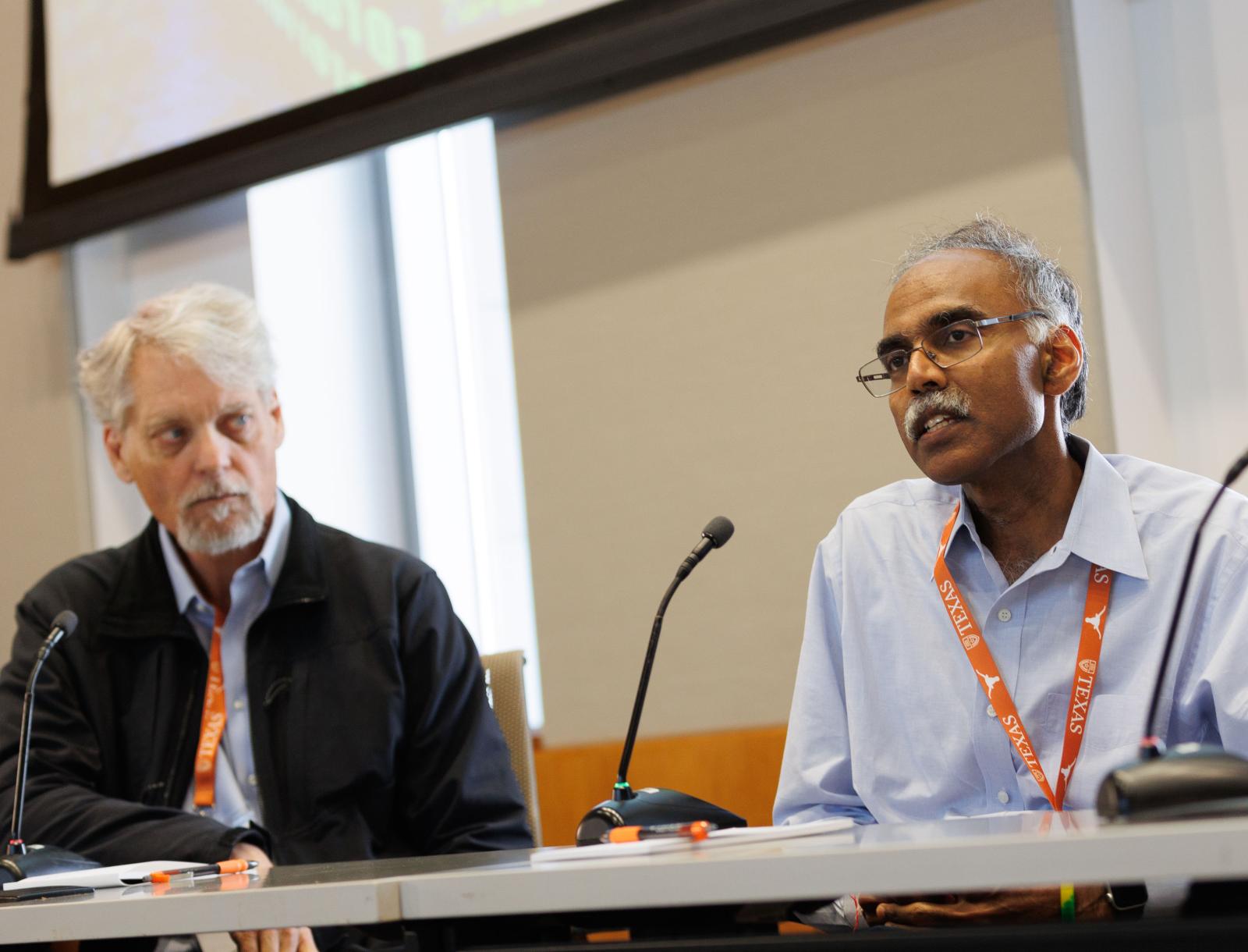 one panelist speaks into microphone while the other listens